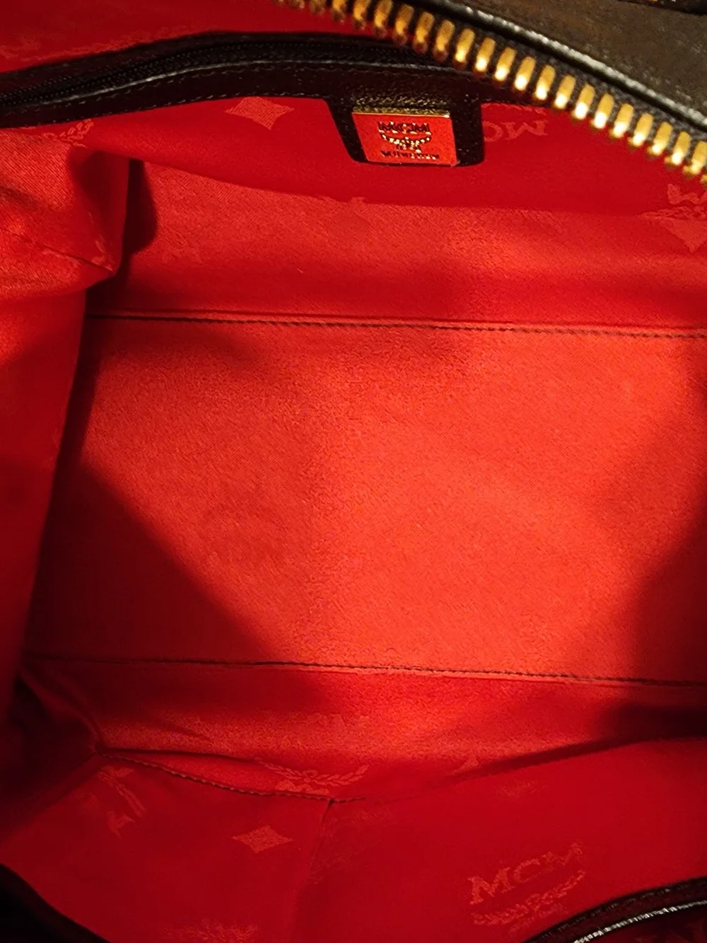 MCM Black Leather Boston Bag featuring polished gold-tone hardware